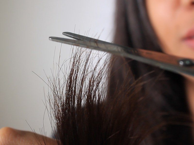 Trim your hair ends to remove splits and maintain hair health and growth