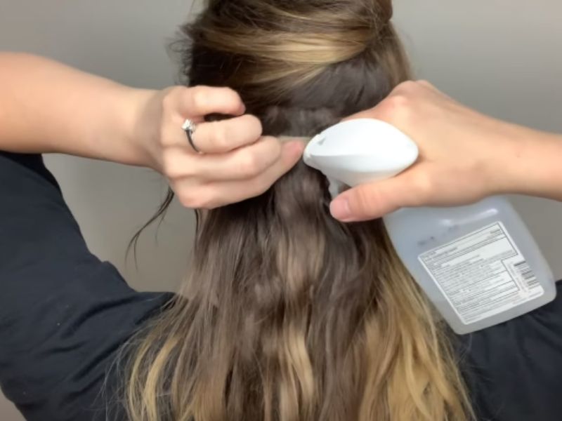 Apply adhesive remover into tape in hair