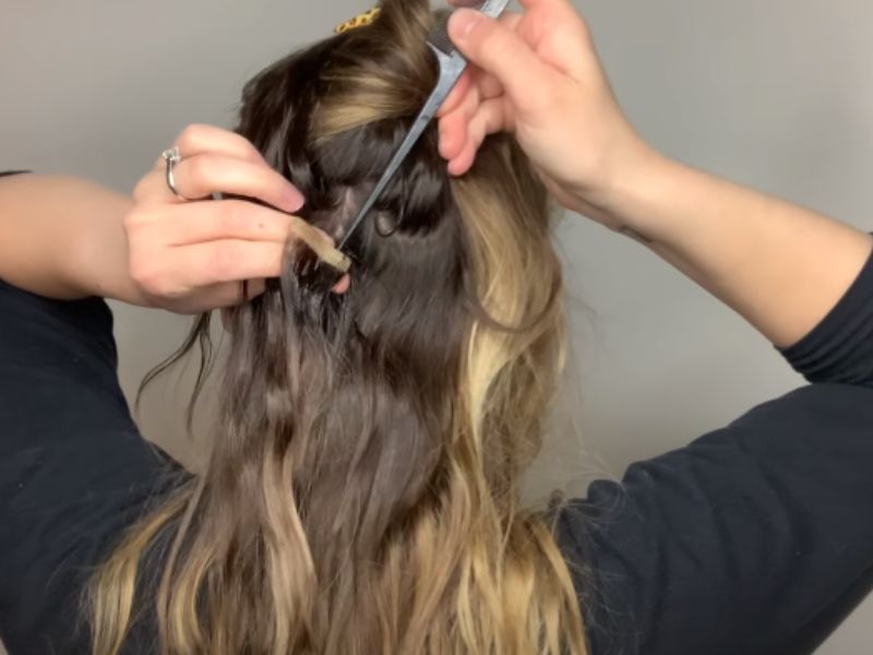 Gently separate the extensions tail comb or your hand
