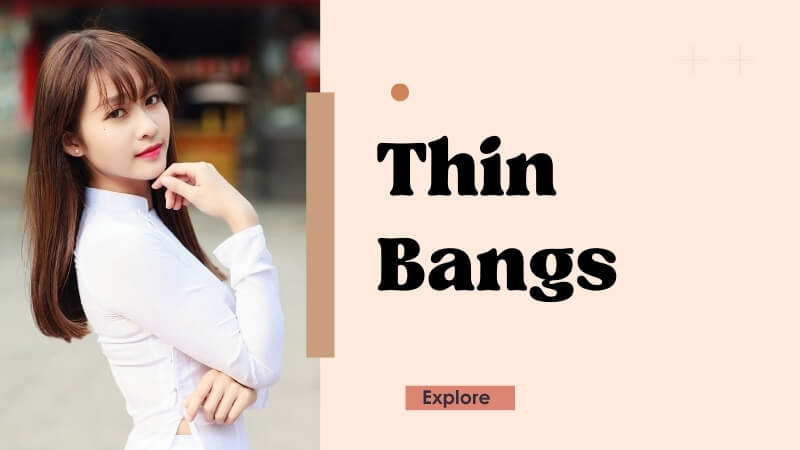 Thin bangs frame the face softly, adding a trendy touch.