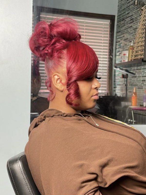 A playful updo that highlights red and pink shades