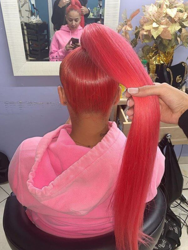 A polished, high ponytail that makes pink red color stand out