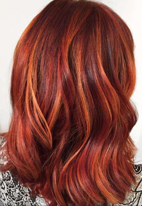 Copper red highlights in chestnut brown hair
