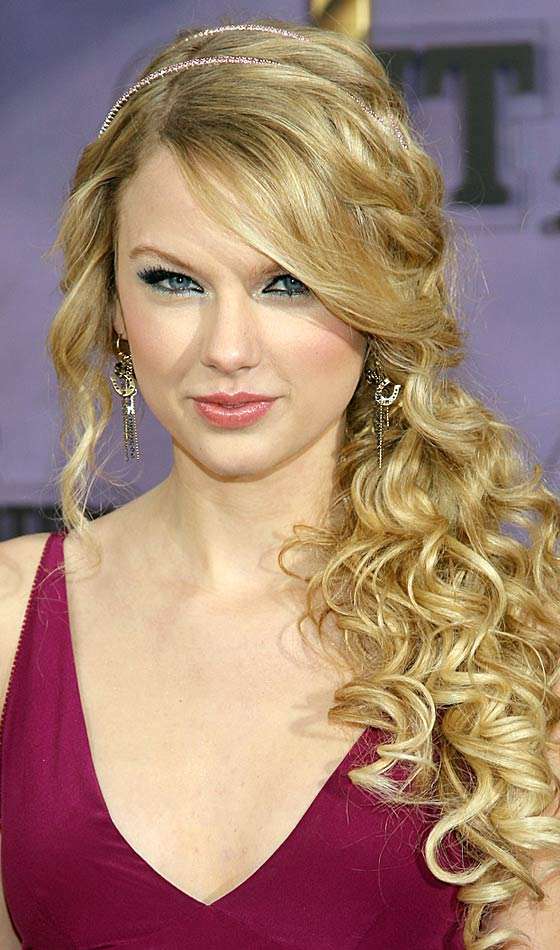 Curly low ponytail with long wispy bangs