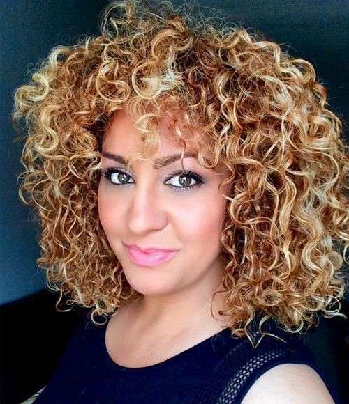 Curly short brown hair with Bright caramel highlights