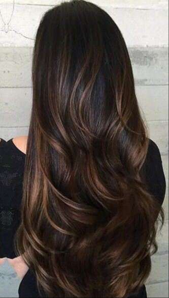 Wavy ends of hair with very dark brown hair with caramel highlights