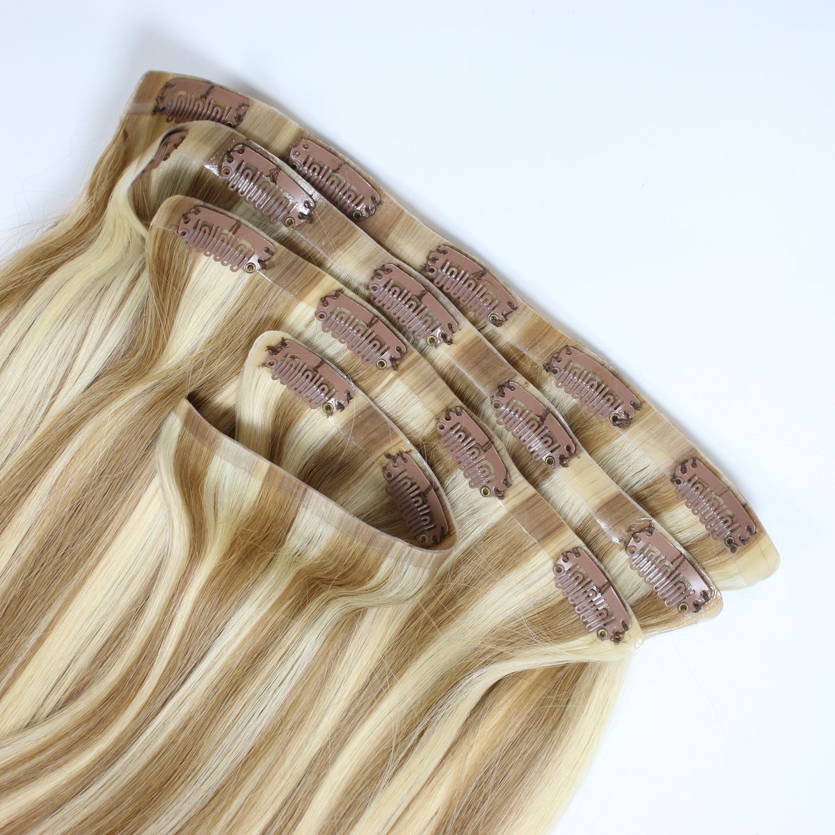 A seamless clip-in set in blonde with highlights