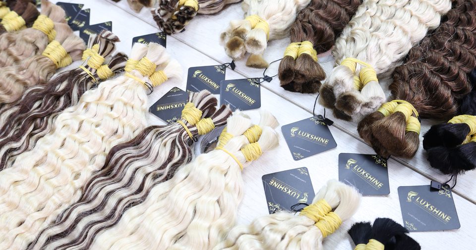 Finished hair bundles laid out with Luxshine tags before shipping